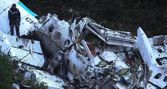The torn fuselage of the air ambulance lies scattered in the undergrowth, illuminated by search lights as rescue teams comb the site.